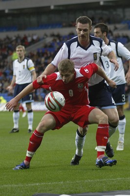 14.11.09  Wales v Scotland - International Football friendly - Wales' Simon Church holds off Stephen McManus. 