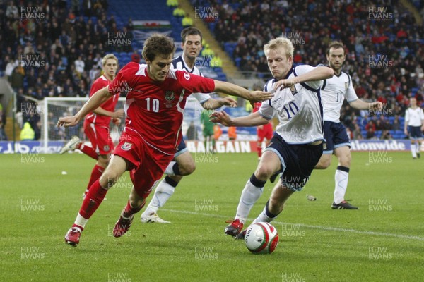 14.11.09  Wales v Scotland - International Football friendly - Wales' Aaron Ramsey looks to cross the ball under pressure from Steven Naismith. 