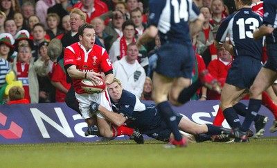 12.02.06..Wales v Scotland, Millennium Stadium, Cardiff Wales Mark Jones looks to make the ball available as he's tackled short of the line 