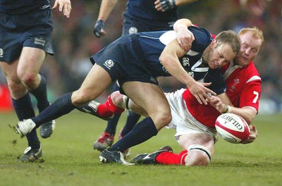 12.02.06..Wales v Scotland, Millennium Stadium, Cardiff Wales' Martyn Williams puts Andrew Henderson under pressure 