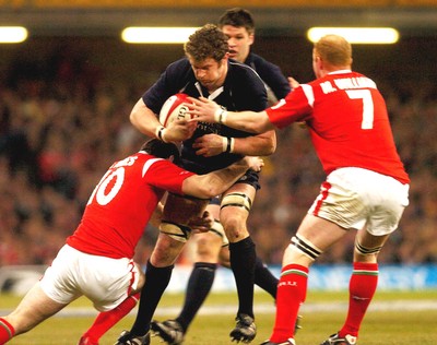 12.02.06 - Six Nations Rugby - Wales v Scotland Scotland's Jason White tries to get between Stephen Jones and Martyn Williams 