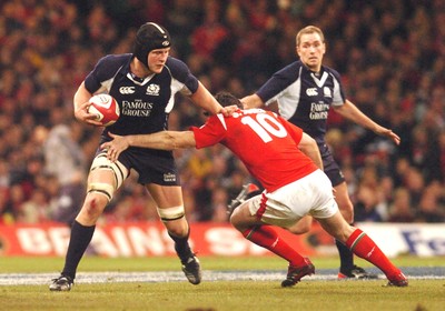 12.02.06 - Six Nations Rugby - Wales v Scotland Scotland's Dan Parks tries to beat a Stephen Jones tackle 