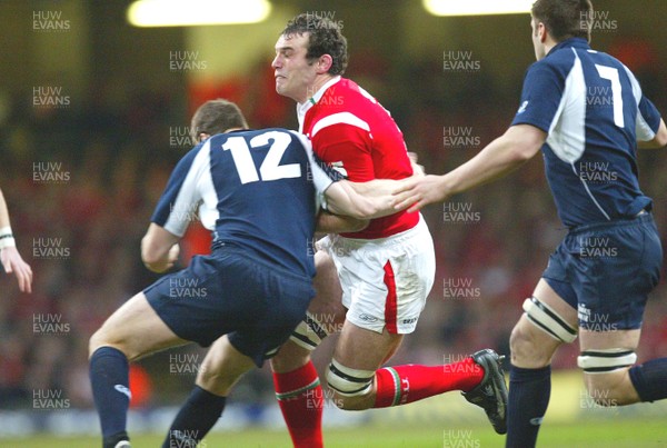 12.02.06..Wales v Scotland, Millennium Stadium, Cardiff Wales Robert Sidoli is tackled by Andrew Henderson 