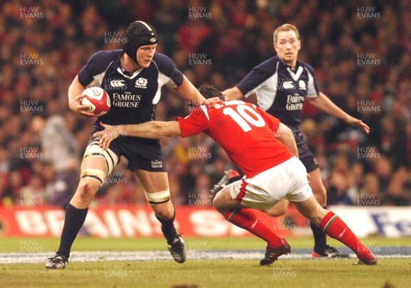 12.02.06 - Six Nations Rugby - Wales v Scotland Scotland's Dan Parks tries to beat a Stephen Jones tackle 