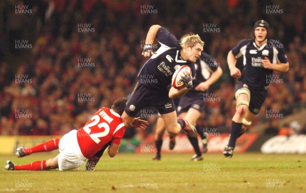12.02.06 - Six Nations Rugby - Wales v Scotland Scotland's Sean Lamont is tackled by Lee Byrne 