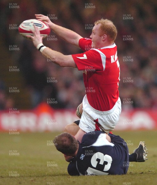 12.02.06  Wales v Scotland  Martyn Williams passes as Ben MacDougall tackles  