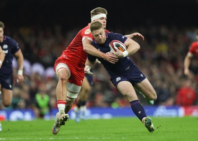 210226 - Wales v Scotland, 2026 Guinness Six Nations - Kyle Steyn of Scotland is tackled by Taine Plumtree of Wales