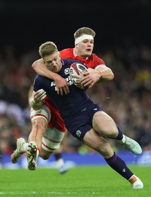 210226 - Wales v Scotland, 2026 Guinness Six Nations - Kyle Steyn of Scotland is tackled by Taine Plumtree of Wales