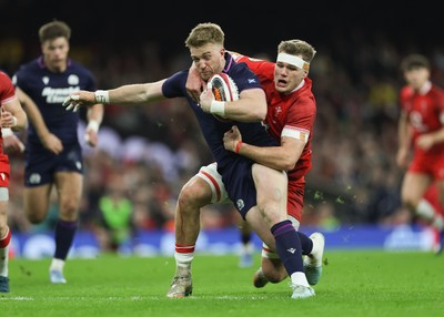210226 - Wales v Scotland, 2026 Guinness Six Nations - Kyle Steyn of Scotland is tackled by Taine Plumtree of Wales
