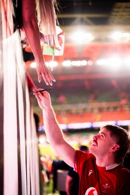 210226 - Wales v Scotland - Guinness Six Nations - Aaron Wainwright signs autographs for fans in the tunnel after the game 