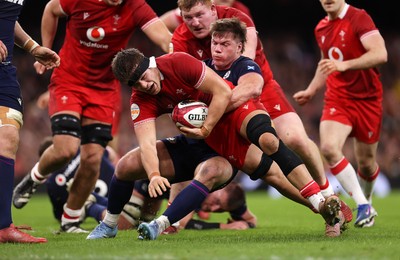 210226 - Wales v Scotland - Guinness Six Nations Championship - Alex Mann of Wales is tackled by Huw Jones of Scotland 