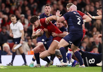 210226 - Wales v Scotland - Guinness Six Nations Championship - Eddie James of Wales is tackled by Finn Russell of Scotland 