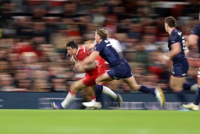 210226 - Wales v Scotland - Guinness Six Nations Championship - Louis Rees-Zammit of Wales is tackled by Duhan van der Merwe of Scotland 