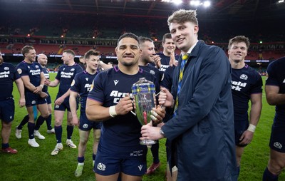 210226 - Wales v Scotland, 2026 Guinness Six Nations - Hamish Weir presents Sione Tuipulotu of Scotland with the Doddie Weir Cup at the end of the match