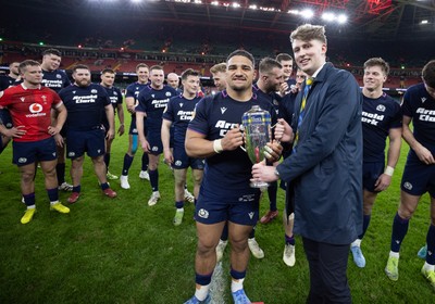 210226 - Wales v Scotland, 2026 Guinness Six Nations - Hamish Weir presents Sione Tuipulotu of Scotland with the Doddie Weir Cup at the end of the match