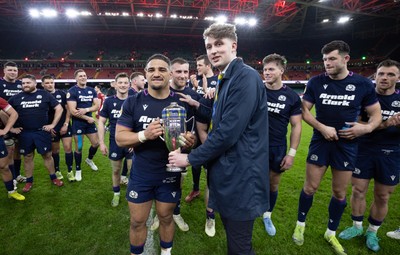 210226 - Wales v Scotland, 2026 Guinness Six Nations - Hamish Weir presents Sione Tuipulotu of Scotland with the Doddie Weir Cup at the end of the match