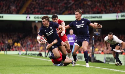 210226 - Wales v Scotland, 2026 Guinness Six Nations - Huw Jones of Scotland takes on Josh Adams of Wales and Louis Rees-Zammit of Wales