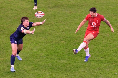 210226 - Wales v Scotland - Guinness Six Nations - Louis Rees-Zammit of Wales kicks the ball