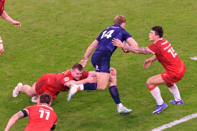 210226 - Wales v Scotland - Guinness Six Nations - Kyle Steyn of Scotland is tackled by Dewi Lake of Wales