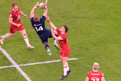 210226 - Wales v Scotland - Guinness Six Nations - Kyle Steyn of Scotland and Jarrod Evans of Wales compete for the ball
