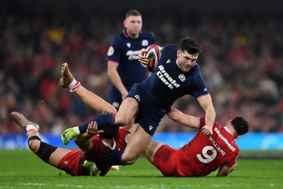 210226 - Wales v Scotland - Guinness Men's Six Nations - Blair Kinghorn of Scotland is challenged by Tomos Williams of Wales