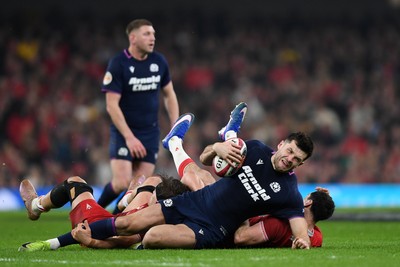 210226 - Wales v Scotland - Guinness Men's Six Nations - Blair Kinghorn of Scotland is challenged by Alex Mann of Wales