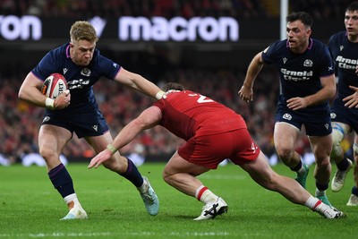 210226 - Wales v Scotland - Guinness Men's Six Nations - Kyle Steyn of Scotland is challenged by Dewi Lake of Wales