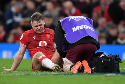 210226 - Wales v Scotland - Guinness Men's Six Nations - Sam Costelow of Wales picks up an injury