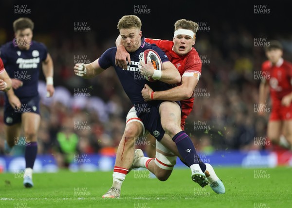 210226 - Wales v Scotland, 2026 Guinness Six Nations - Kyle Steyn of Scotland is tackled by Taine Plumtree of Wales
