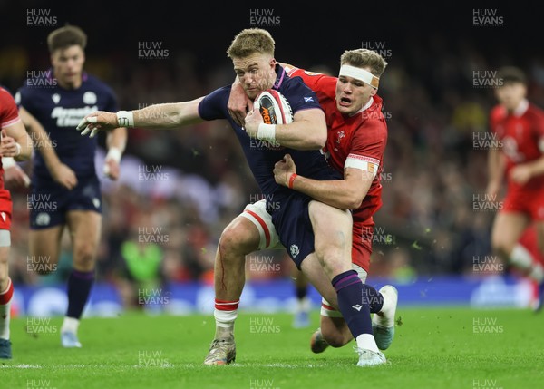 210226 - Wales v Scotland, 2026 Guinness Six Nations - Kyle Steyn of Scotland is tackled by Taine Plumtree of Wales