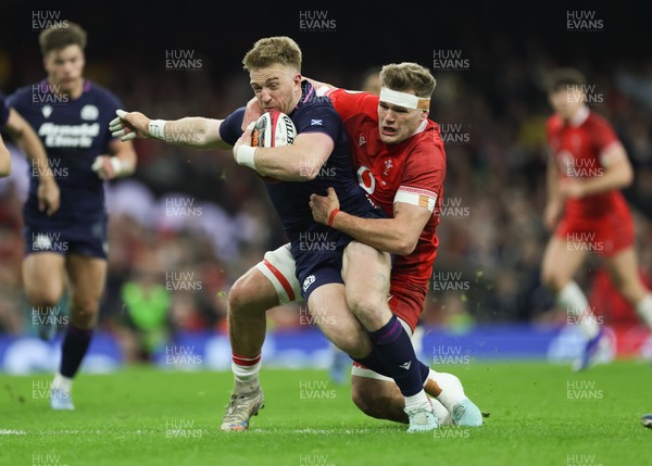 210226 - Wales v Scotland, 2026 Guinness Six Nations - Kyle Steyn of Scotland is tackled by Taine Plumtree of Wales