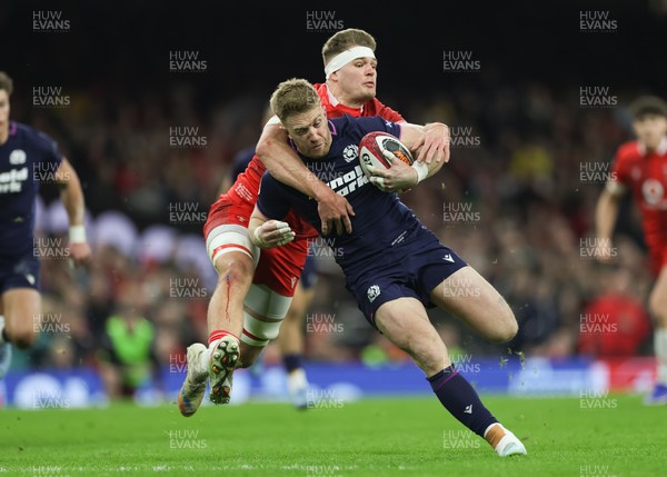 210226 - Wales v Scotland, 2026 Guinness Six Nations - Kyle Steyn of Scotland is tackled by Taine Plumtree of Wales