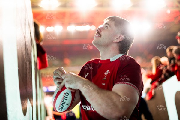 210226 - Wales v Scotland - Guinness Six Nations - Aaron Wainwright signs autographs for fans in the tunnel after the game 