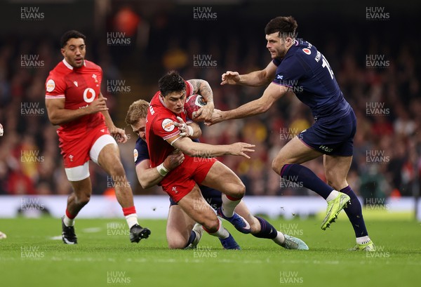 210226 - Wales v Scotland - Guinness Six Nations Championship - Louis Rees-Zammit of Wales is tackled by Kyle Steyn of Scotland 