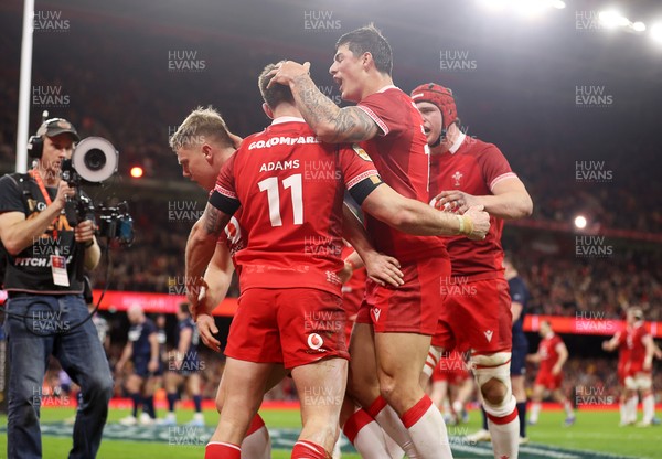 210226 - Wales v Scotland - Guinness Six Nations Championship - Josh Adams of Wales celebrates scoring a try with team mates