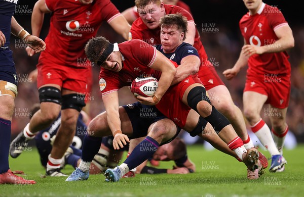 210226 - Wales v Scotland - Guinness Six Nations Championship - Alex Mann of Wales is tackled by Huw Jones of Scotland 