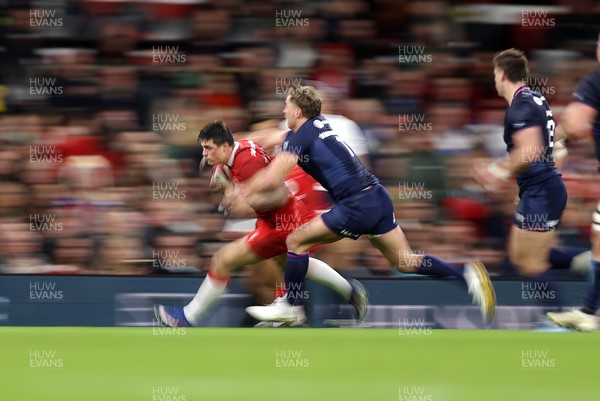 210226 - Wales v Scotland - Guinness Six Nations Championship - Louis Rees-Zammit of Wales is tackled by Duhan van der Merwe of Scotland 