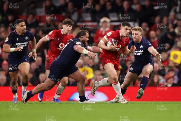 210226 - Wales v Scotland - Guinness Six Nations Championship - Joe Hawkins of Wales is challenged by Pierre Schoeman of Scotland 