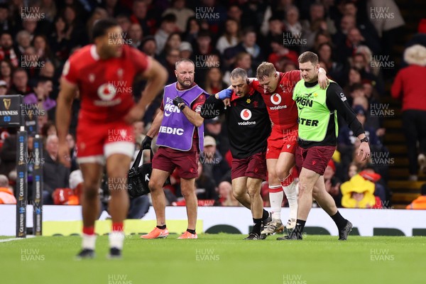 210226 - Wales v Scotland - Guinness Six Nations Championship - Sam Costelow of Wales goes off the field injured