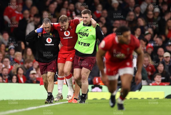 210226 - Wales v Scotland - Guinness Six Nations Championship - Sam Costelow of Wales goes off the field injured