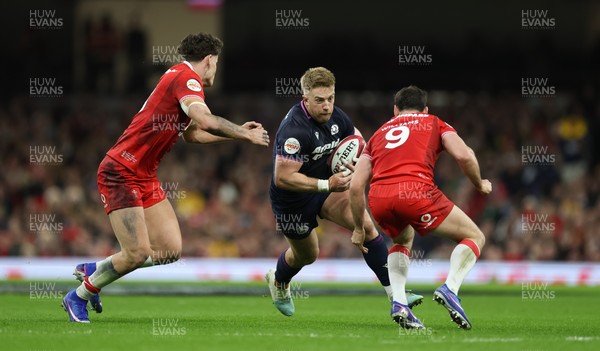 210226 - Wales v Scotland, 2026 Guinness Six Nations - Kyle Steyn of Scotland takes on Eddie James of Wales and Tomos Williams of Wales