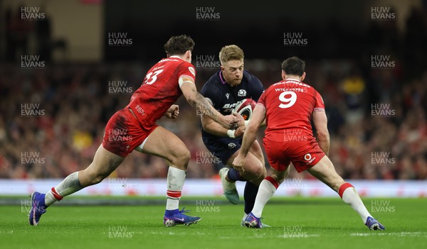 210226 - Wales v Scotland, 2026 Guinness Six Nations - Kyle Steyn of Scotland takes on Eddie James of Wales and Tomos Williams of Wales
