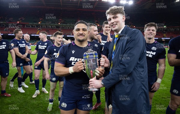 210226 - Wales v Scotland, 2026 Guinness Six Nations - Hamish Weir presents Sione Tuipulotu of Scotland with the Doddie Weir Cup at the end of the match