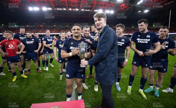 210226 - Wales v Scotland, 2026 Guinness Six Nations - Hamish Weir presents Sione Tuipulotu of Scotland with the Doddie Weir Cup at the end of the match