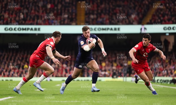 210226 - Wales v Scotland, 2026 Guinness Six Nations - Huw Jones of Scotland takes on Josh Adams of Wales and Louis Rees-Zammit of Wales
