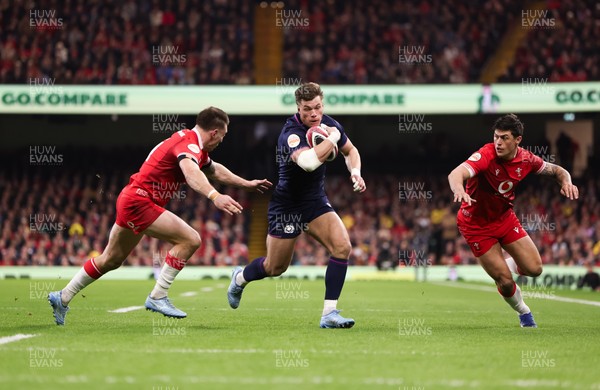 210226 - Wales v Scotland, 2026 Guinness Six Nations - Huw Jones of Scotland takes on Josh Adams of Wales and Louis Rees-Zammit of Wales