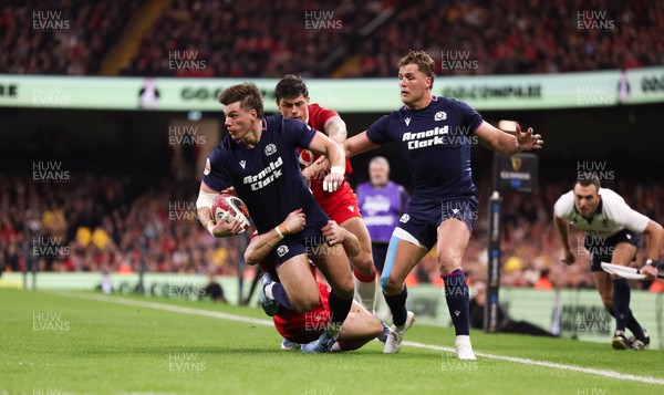 210226 - Wales v Scotland, 2026 Guinness Six Nations - Huw Jones of Scotland takes on Josh Adams of Wales and Louis Rees-Zammit of Wales