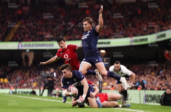 210226 - Wales v Scotland, 2026 Guinness Six Nations - Huw Jones of Scotland takes on Josh Adams of Wales and Louis Rees-Zammit of Wales