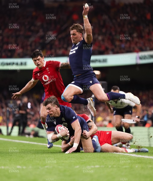 210226 - Wales v Scotland, 2026 Guinness Six Nations - Huw Jones of Scotland takes on Josh Adams of Wales and Louis Rees-Zammit of Wales