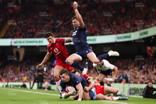 210226 - Wales v Scotland, 2026 Guinness Six Nations - Huw Jones of Scotland takes on Josh Adams of Wales and Louis Rees-Zammit of Wales